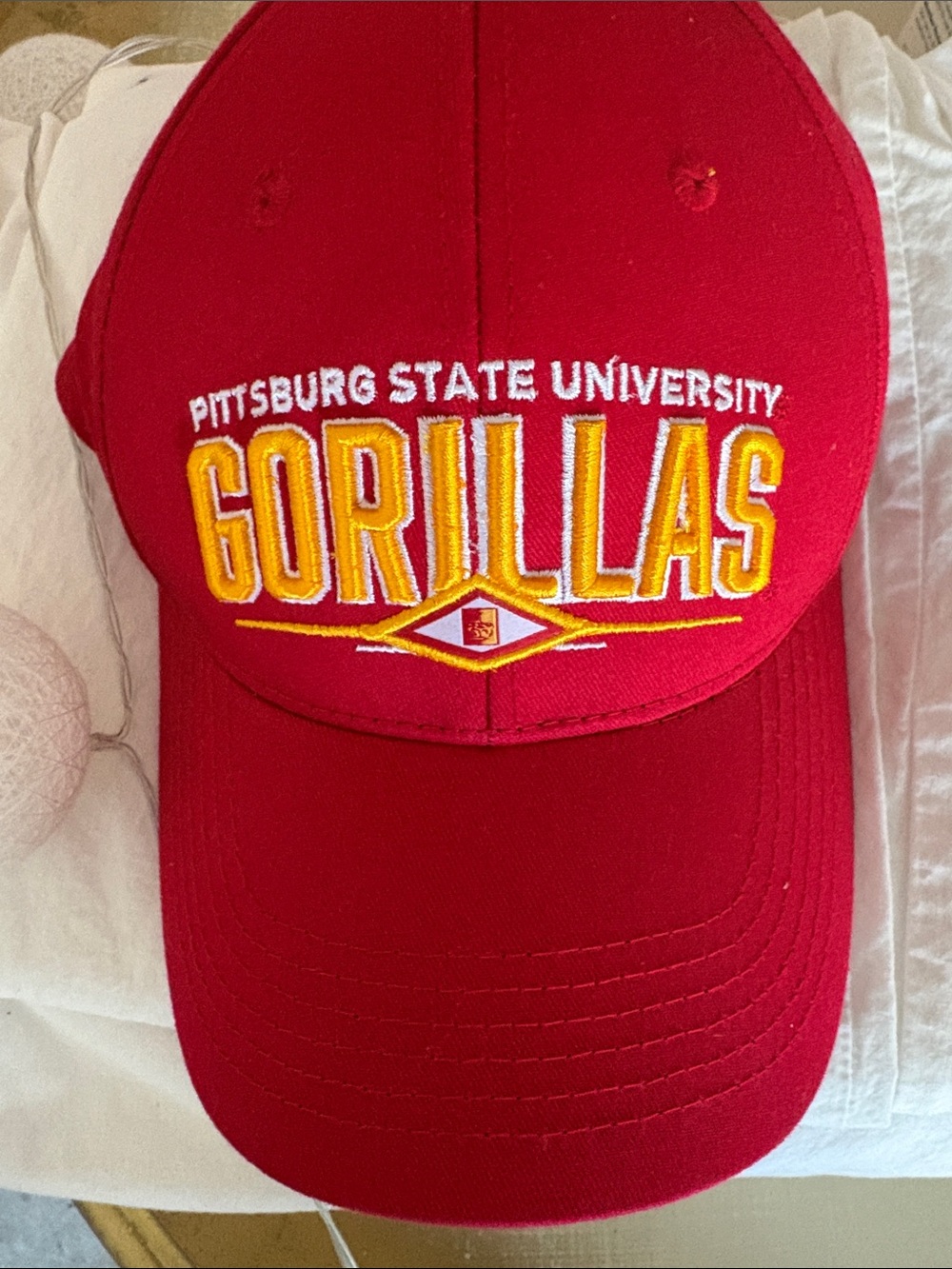 Pittsburg State University Gorillas Cap along with various other hats